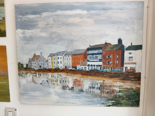 Signed oil painting by Sentoni depicting a waterfront townscape with period buildings reflected in estuary water